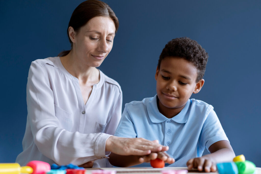 Occupational therapist helping a kid in therapy activities.